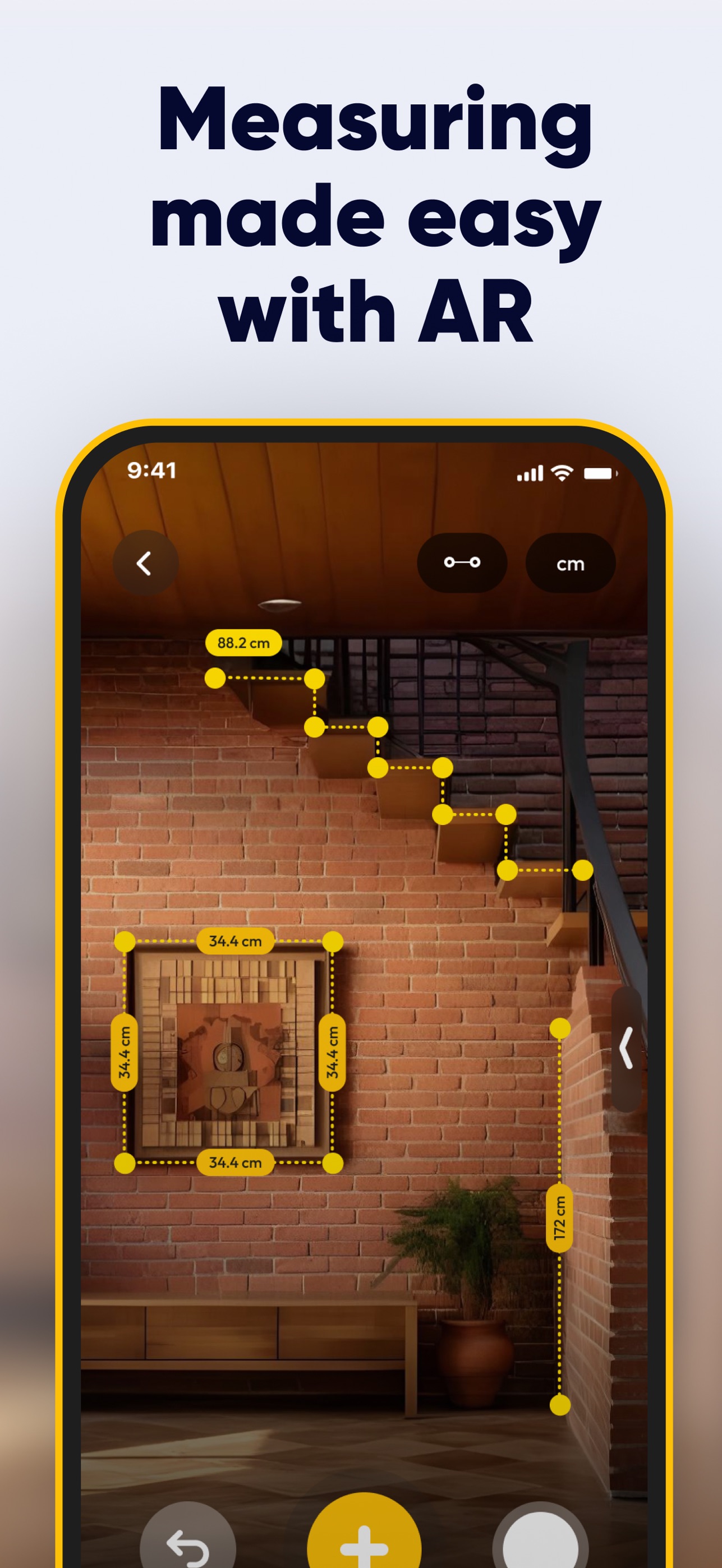 SmartRuler measuring a framed picture on a brick wall in AR